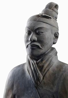 a close up of a statue of a man wearing a hat