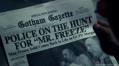 a person holding up a newspaper with the caption police on the hunt for mr freeze