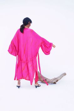 An impressive statement piece, the Miko - Fuchsia Kimono Robe & Jacket is as luxurious as it is versatile. With its chic Fuschia hue, this sophisticated piece can easily elevate any look. Ideal for a sophisticated night out, wear this jacket over a jumpsuit or little black dress and heels. Features: Soft feel Lightweight feel Very comfortable Handmade Oversized fit Puffy sleeves Oversized -One size all fit Removable waist tie closure with loops Side slits at hem No pockets Hand wash in cold wate Pink Kimono For Fall Vacation, Pink Fall Vacation Kimono, Chic Pink Wrap Kimono, Fitted Pink Summer Kimono, Pink Party Kimono, Pink Spring Party Kimono, Spring Party Pink Kimono, Fitted Pink Kimono, Pink Long Sleeve Kimono For Party