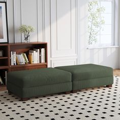 a living room scene with focus on the footstool and bookshelf in the background