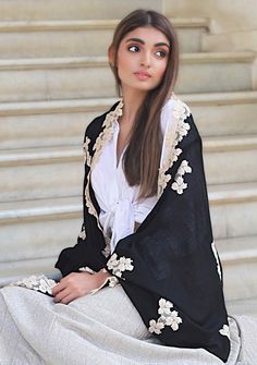 This black scarf, woven from a fine blend of silk and wool, is bordered and hand appliqued with a contrasting and delicate shiny light gold leaf-patterned lace. It is the perfect size that keeps you comfortably warm whilst making for a fashionable and contemporary accessory for any evening wear. Elegant Pashmina Shawl For Eid, Elegant Eid Pashmina Shawl, Elegant Embroidered Shawl For Eid, Festive Black Pashmina Shawl With Embroidered Border, Festive Black Shawl With Embroidered Border, Elegant Scarves For Eid Festival, Elegant Black Shawl For Eid, Elegant Festive Scarves For Eid, Elegant Silk Shawl For Eid