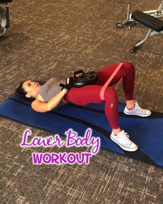 a woman laying on top of a blue mat in a gym