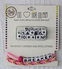 two pieces of white and pink bead with letters on them, one has the word breaker spelled in black