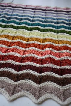 a crocheted blanket with different colors on it