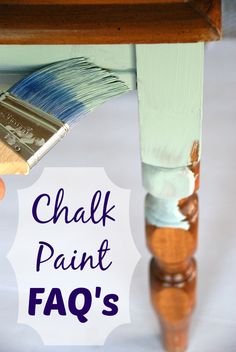 a person holding a paintbrush under a table with the words chalk paint faq's on it