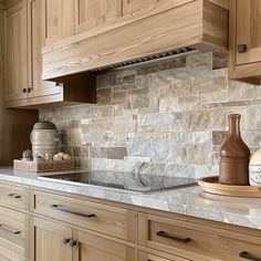 a kitchen with wooden cabinets and marble counter tops