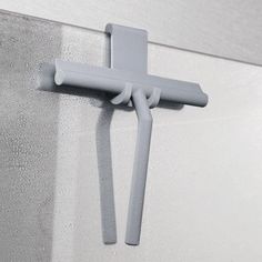 a cross hanging on the side of a wall next to a metal door handle,