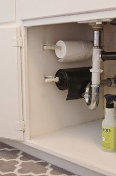 an image of a sink that is under the faucet and has two rolls of toilet paper in it