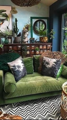 a living room filled with green couches and lots of plants on top of them