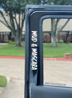 the side view mirror of a truck with writing on it's side door window