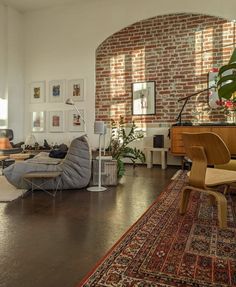 a living room filled with furniture and lots of windows