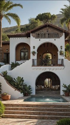 a large white house with steps leading to the front door and entry way that leads to an outdoor swimming pool