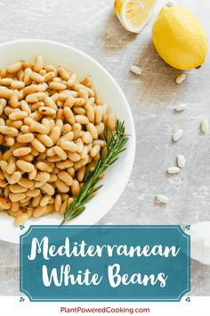 white beans in a bowl with lemons and rosemary sprigs on the side