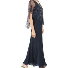 This J Kara Dress In A Rich Navy Blue Offers Timeless Sophistication, Perfect For Evening Events And Formal Occasions. The Delicate Beaded/Sequined Capelet Adds A Touch Of Sparkle And Glamour, Making This Dress A Standout Choice For Special Nights. A Chiffon Overlay Provides A Long, Flowing Silhouette Creating An Elegant And Graceful Look. Size Is 14p, Was Hemmed To 55” (Top Of Shoulder To Bottom Of Hem) New Without Tags, Never Worn. The Color Varies In The Pictures And I Took Them Indoors And O Elegant Flowy Blue Evening Dress, Elegant Blue Flowy Evening Dress, Blue Flowy Evening Dress, Summer Evening Embellished Mother Of The Bride Dress, Summer Embellished Mother Of The Bride Evening Dress, Embellished Flowy Evening Dresses, Evening Flowy Embellished Dresses, Elegant Embellished Flowy Dress, Flowy Embellished Evening Dresses