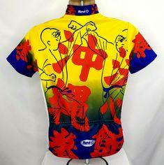 a yellow shirt with red and blue designs on the front is hanging from a mannequin's head