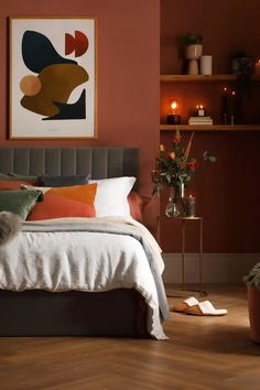 a bedroom with red walls and wooden floors