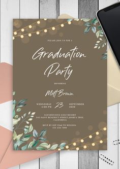 a graduation party card with greenery and lights on it, next to an envelope