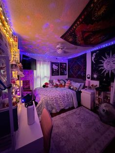 a bed room with a neatly made bed and lots of lights on the ceiling above it