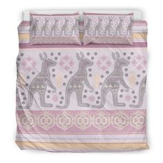 a bed with two giraffes on it in pink and yellow colors,