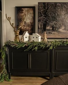 a black dresser with christmas decorations on top