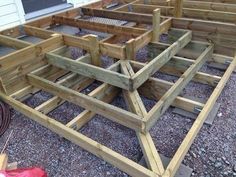 several wooden benches sitting on top of gravel