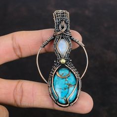 Note : Due to the natural formation of this gemstone. Slight variation in design and color are to be expected. Tibetan Turquoise Copper Pendant Wire Wrapped Gemstone Pendant Rainbow Moonstone Pendant Copper Wire Wrap Jewelry Handmade Pendant For Gifts Handmade Copper Pendant SKU : VFWP-4421 Gemstone : 1: Tibetan Turquoise                       2: Rainbow Moonstone Stone Shape : 1: Oval                           2: Oval Metal Purity : Copper Pendant Length : 80 MM   Pendant Width : 42 MM It is al Turquoise Pendant Gemstone, Turquoise Natural Stones Pendant Gemstones, Turquoise Natural Stone Pendant, Spiritual Turquoise Moonstone Jewelry, Handmade Turquoise Fusion Jewelry, Handmade Fusion Turquoise Jewelry, Handmade Turquoise Gemstone Pendant, Bohemian Cabochon Gemstones For Jewelry Making, Handmade Turquoise Gemstones For Gifts