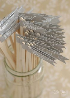 toothpicks are placed in a mason jar with name tags on them that say congratulations