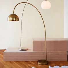 the floor lamp is next to some folded paper