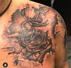 a man with a compass tattoo on his chest