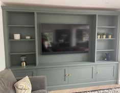 a large entertainment center with built in shelves