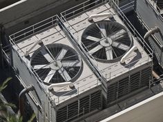 two air conditioning fans on the roof of an apartment building stock photo - 957982