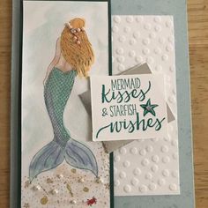 a card with a mermaid on it and a note that says mermaid kisses & starfish wishes