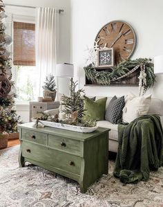 a living room decorated for christmas with green accents and decorations on the wall, along with a large clock