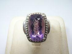 "Up for your consideration is this Vintage Sterling Silver Ring. This ring is set with a gorgeously large and faceted amethyst in the center (approx.: 9 carats); prong set. The amethyst is accented with a halo of silver beads around it. The sides of the band have deep grooves that stop halfway down; just gorgeous. Pictures best describe. Excellent condition, no damage. Ring Size is Approx.: 7.25. Measurement of Ring is Approx.: 3/4\" wide across the front. I tested this piece with acid and it is Poison Ring, Mother Of Pearl Earrings, Vintage Sterling Silver Rings, Amethyst Gem, Purple Band, Amethyst Ring, Rings Statement, Sterling Silber, Silver Beads