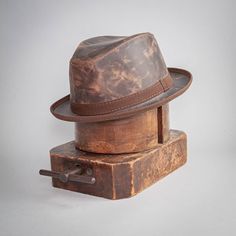 Soho | Mens Trilby Leather Fedora Hat – American Hat Makers Leather Fedora Hat, Brown Rugged Fedora With Curved Brim, Rugged Brown Fedora With Curved Brim, Classic Leather Fedora With Flat Brim, Classic Leather Fedora, Classic Brown Hat With Waxed Finish, Rugged Leather Hat Bands, Brown Leather Brimmed Fedora, Brown Rugged Fedora With Flat Brim