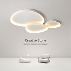 an advertisement for creative stone, featuring two chairs and a round light fixture on the ceiling