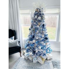 a blue and white christmas tree in a living room