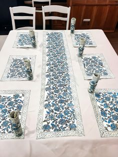 the table is set with blue and white place mats