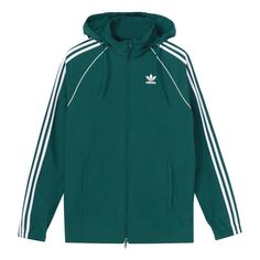 Sporty Adidas Windbreaker For Winter, Adidas Sporty Track Jacket With Logo, Adidas Nylon Track Jacket For Streetwear, Sporty Adidas Track Jacket, Sporty Hooded Windbreaker With Adidas Logo, Urban Hooded Track Jacket With Adidas Logo, Sporty Adidas Windbreaker With Logo, Urban Style Hooded Track Jacket With Adidas Logo, Adidas Track Jacket For Streetwear