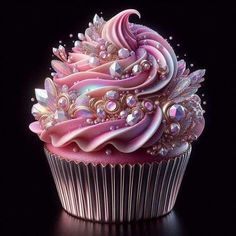 a cupcake with pink frosting and jewels on top