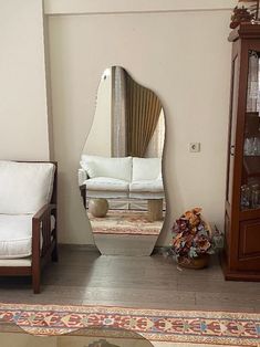 a living room filled with furniture and a large mirror in the middle of the room