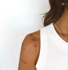 a woman with tattoos on her arm and shoulder