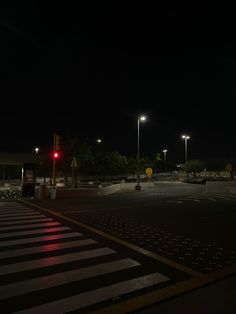 an empty parking lot at night with street lights