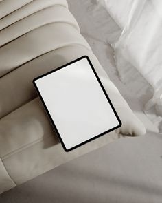 a white pillow with a black square frame on it's back and the rest of its arm