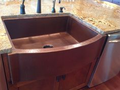 a kitchen sink sitting on top of a wooden counter