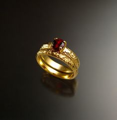 This is a beautiful Natural red Garnet. The 5 mm stone is eye clean and set in 14k Yellow Gold with 3.25mm wide by 1.5mm thick band in a vintage style floral pattern.  Garnet rates a 7 on the Mohs scale for hardness. Comes with matching 2.5mm band.  I can make this ring for you in any size between 4 and 10.  Specify your ring size at check-out. Sapphire Wedding Set, Garnet Wedding Rings, Ruby Wedding Rings, Garnet Wedding, Sapphire Wedding Rings, Ruby Ring Gold, Red Spinel, Future Engagement Rings, Stone Wedding