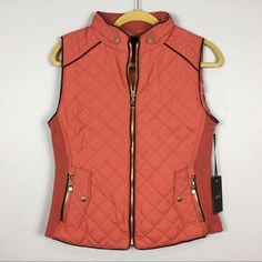 Warm and cozy quilted vest from Active USA vest is dusty pink (terra cotta) in color with dark brown piping details, zippered front, stretchy knit side panels for an easy fit, 2 zip pockets with a faux flap with snap pockets 100% polyester, hand wash Brand new with tags Women's size Medium chest 38" without stretching Length 22" Basic Quilt, Womens Puffer Vest, Quilted Puffer Vest, Quilted Vest, Puffer Vest, Terra Cotta, Side Panels, Panel Siding, Dusty Pink