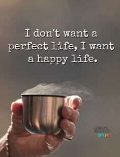 a person holding a cup with the words i don't want a perfect life, i want a happy life