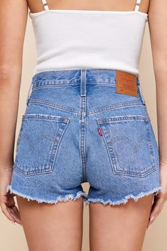 Warm weather is here and it is time to show off those sweet stems in the Levi's 501 Original High-Rise Medium Wash Distressed Denim Shorts! Sturdy cotton denim (in Levi's Athens wash) shapes these cute cutoffs with a classic five-pocket cut, belt loops, branded top button, and a hidden button fly. Light distressing and shredded cut-off hems lend a laid-back vibe! Red logo tag and leather patch at back. Fit: This garment fits true to size. Length: Above mid-thigh. Size 28 Inseam: 2.50 Front Rise: Everyday Cutoff Jean Shorts With Frayed Hem, Levi's Relaxed Fit Jean Shorts With Frayed Hem, Levi's Jean Shorts With Frayed Hem For Spring, Everyday Cotton Jean Shorts With Frayed Hem, Levi's Cotton Jean Shorts For Spring, Fitted Levi's Jean Shorts With Frayed Hem, Everyday Jean Shorts With Frayed Hem In Medium Wash, Spring Everyday Cutoff Jean Shorts, Cotton Jean Shorts For Everyday Spring Wear