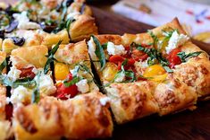 a close up of a pizza on a wooden table